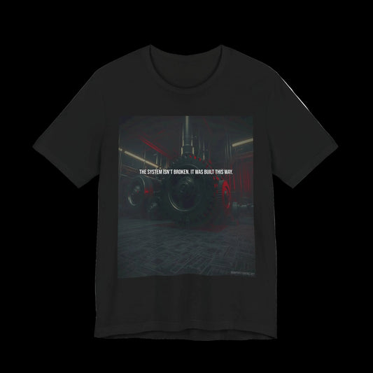 The System Isn't Broken. It Was Built This Way. — T-Shirt